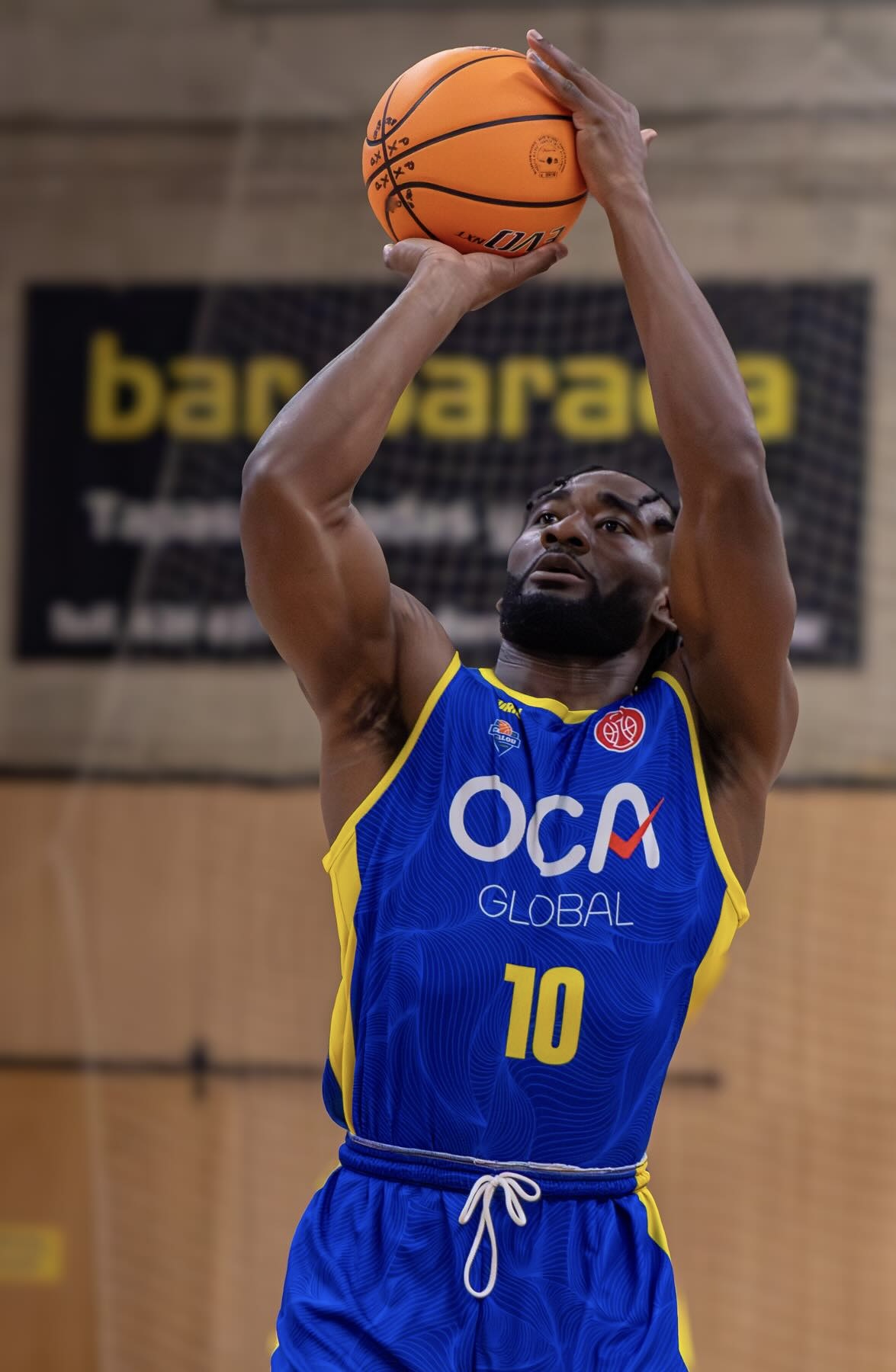 Eric Okenchi rising up for a jump shot during a professional game
